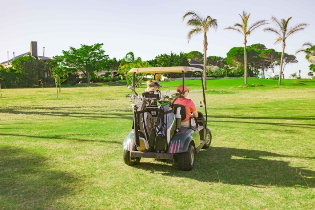 Two golfers in an upgraded golf cart at the course